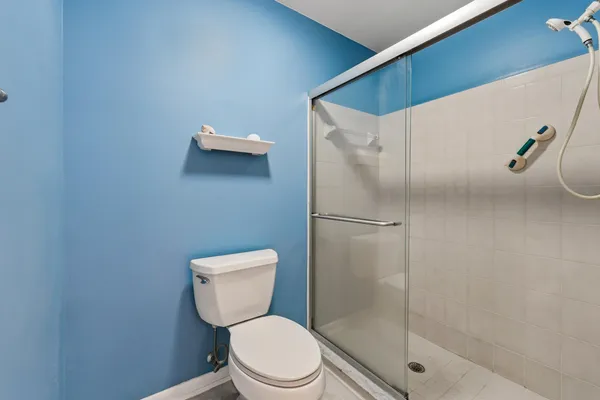 a bathroom with a toilet and a shower