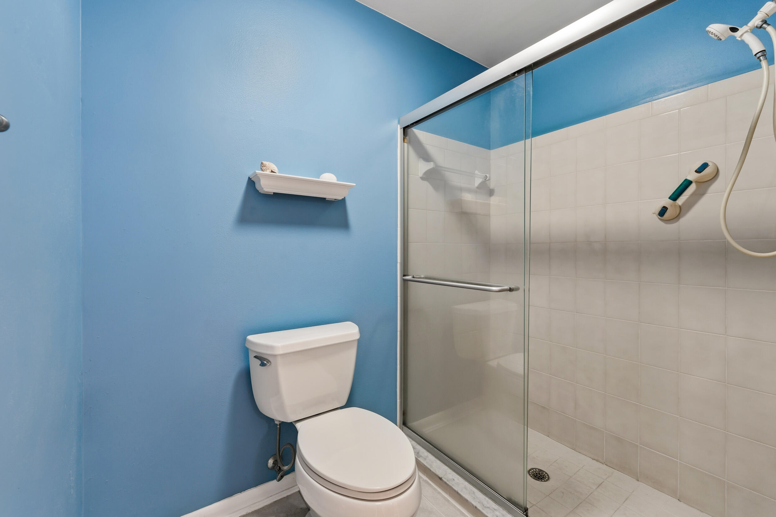 7873 Southeast Sugar Sand Circle Hobe Sound, FL 33455 - Photo 18 of 35 a bathroom with a toilet and a shower