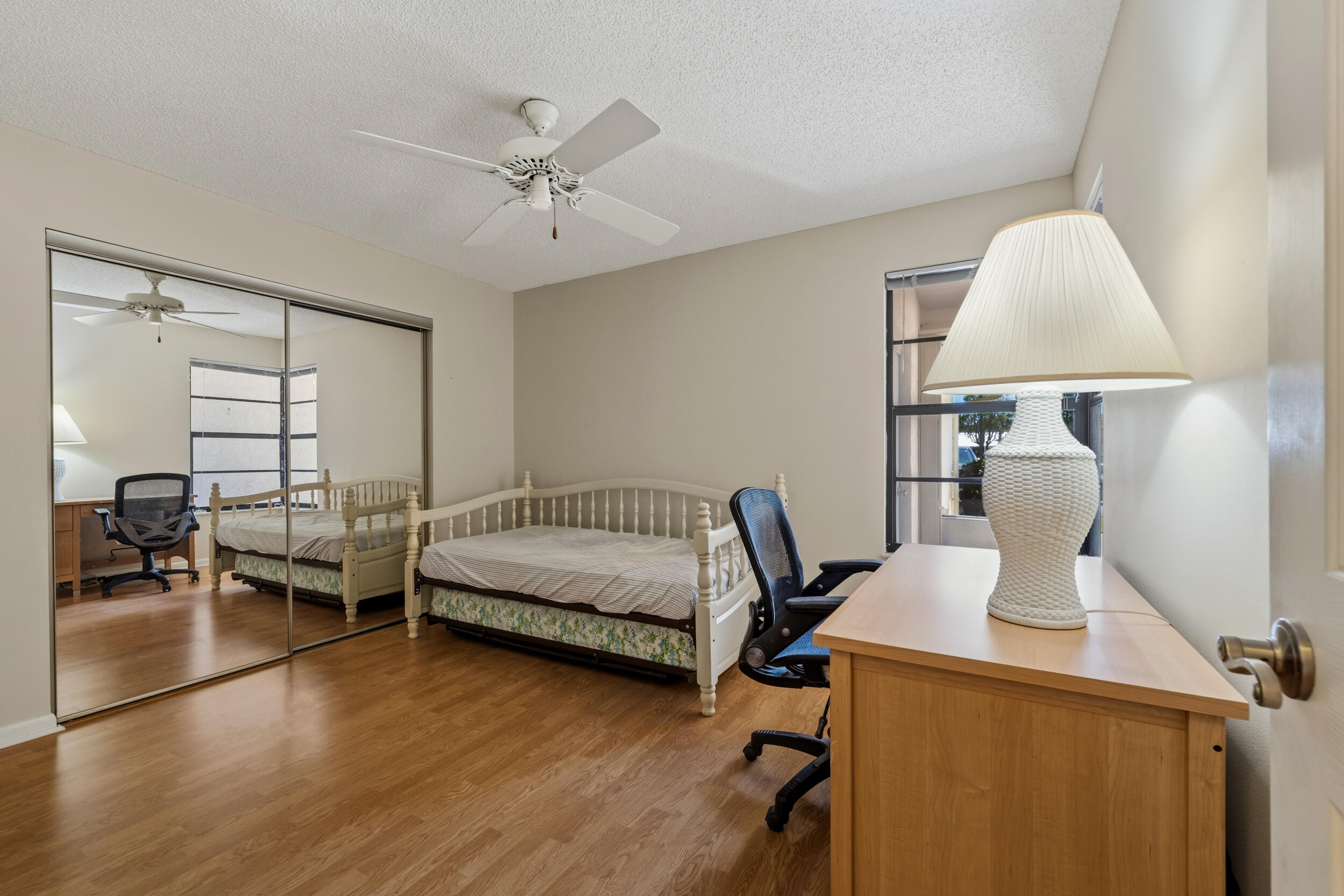 7873 Southeast Sugar Sand Circle Hobe Sound, FL 33455 - Photo 20 of 35 a bedroom with furniture window and wooden floor