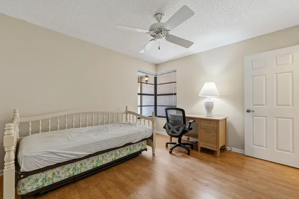 a bedroom with a bed a desk and chair
