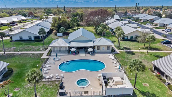 an aerial view of a house with swimming pool patio and outdoor seating