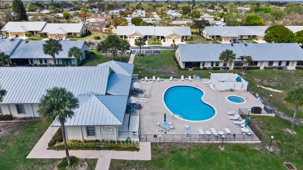 an aerial view of a house with outdoor space and parking