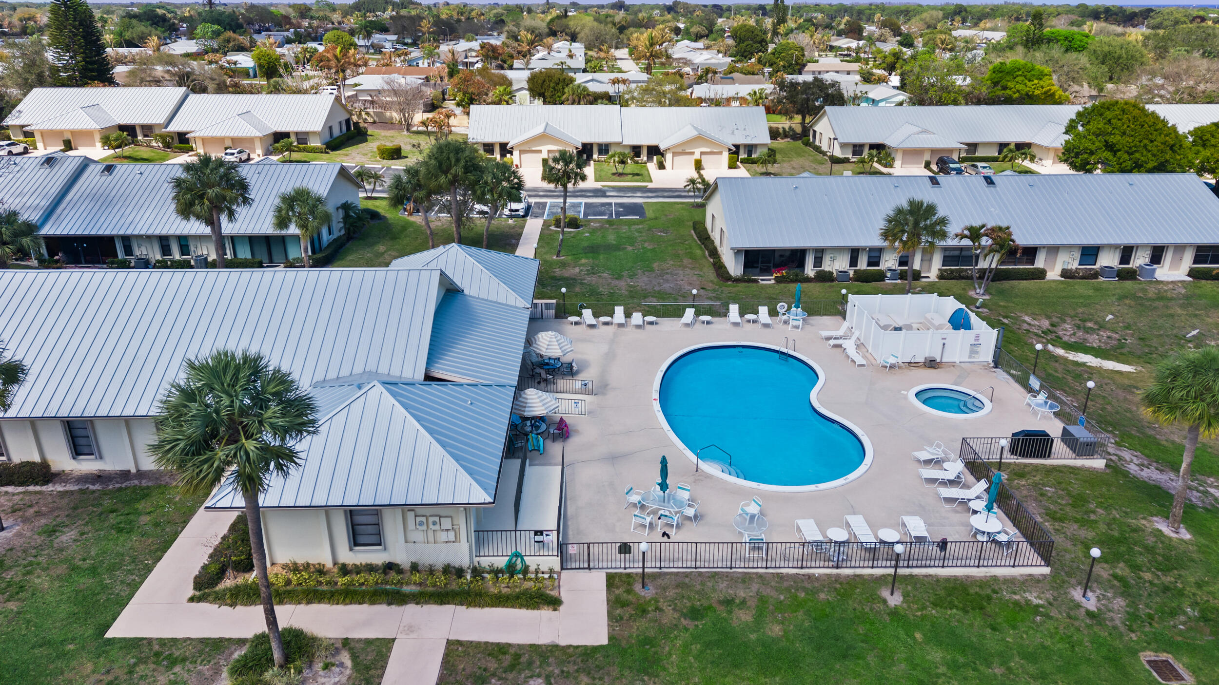 7873 Southeast Sugar Sand Circle Hobe Sound, FL 33455 - Photo 28 of 35 an aerial view of a house with outdoor space and parking