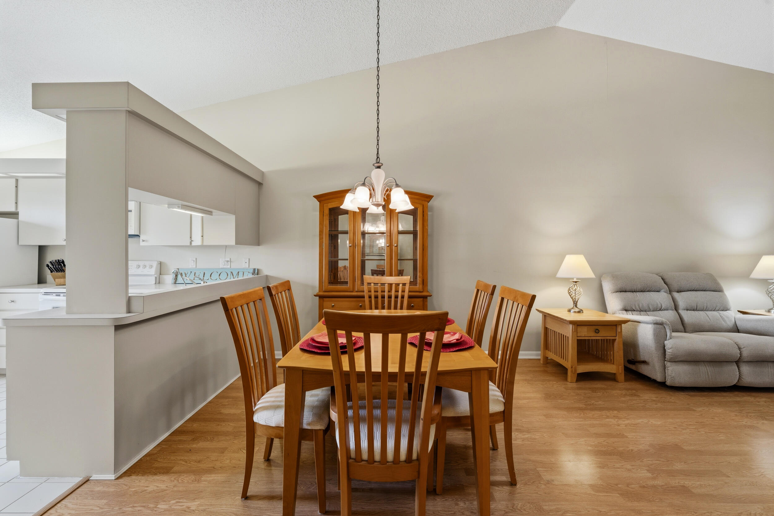 7873 Southeast Sugar Sand Circle Hobe Sound, FL 33455 - Photo 8 of 35 a view of a dining room with furniture window and wooden floor