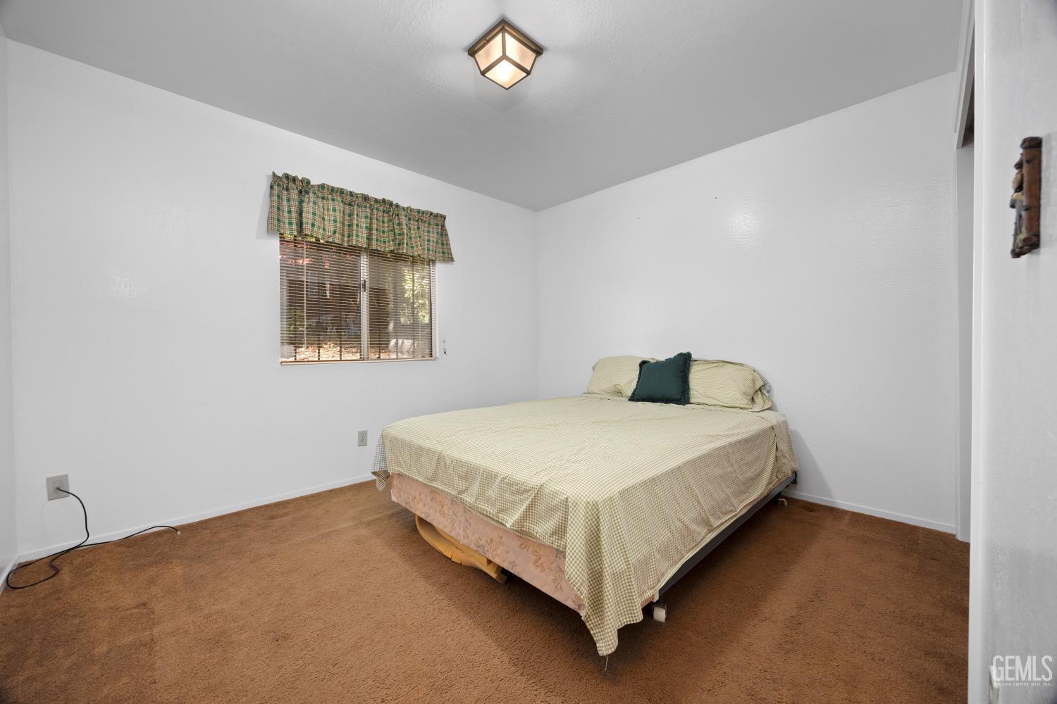 Undisclosed Address Wofford Heights, CA 93285 - Photo 19 of 26 a bedroom with a bed and window
