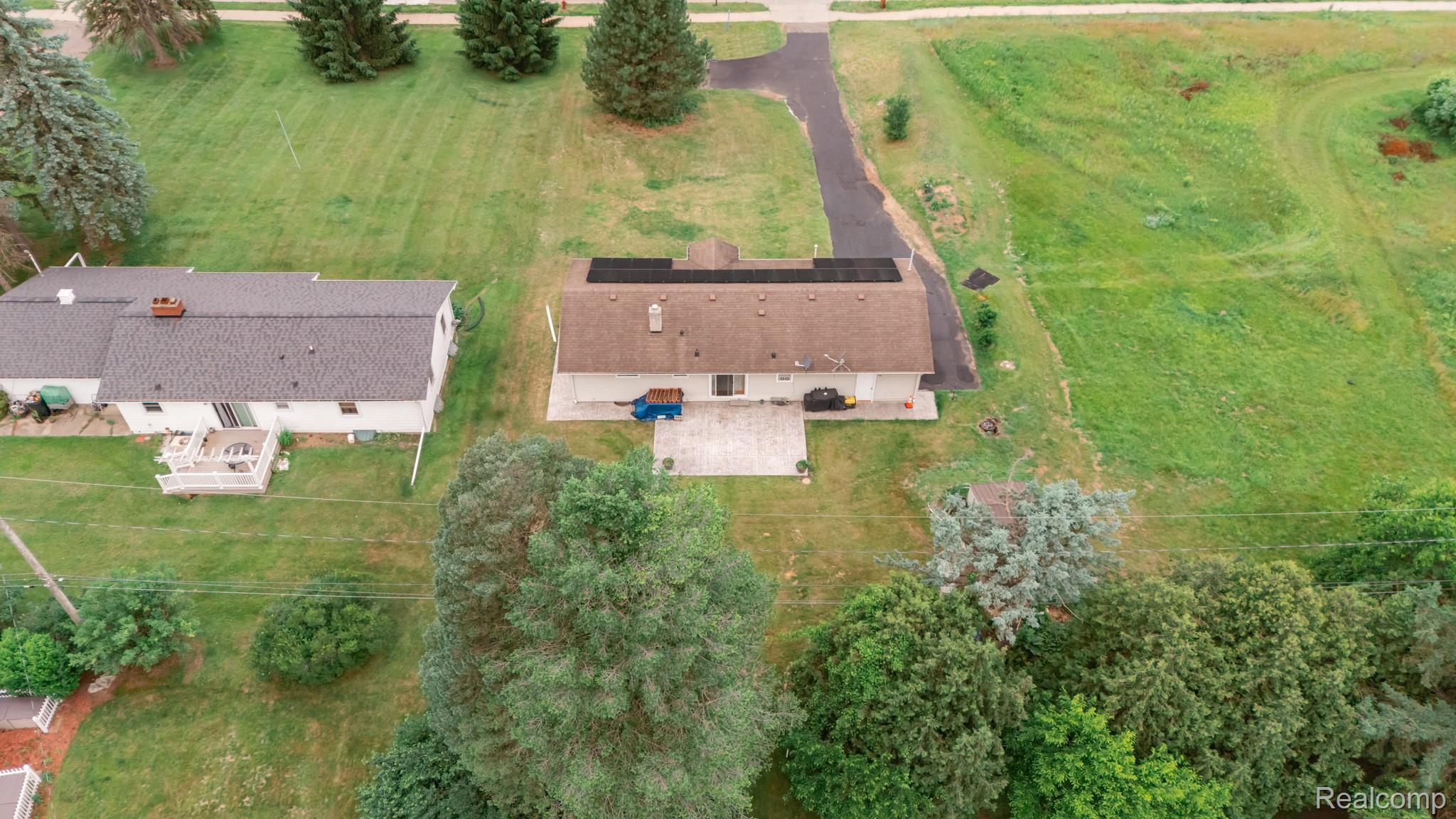 3882 Okemos Road Okemos, MI 48864 - Photo 44 of 50 Aerial view showcasing a brick residence situated on expansive grounds with mature landscaping, including established trees and manicured lawn