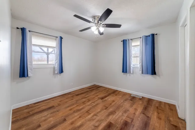 a view of a livingroom with a ceiling fan and window