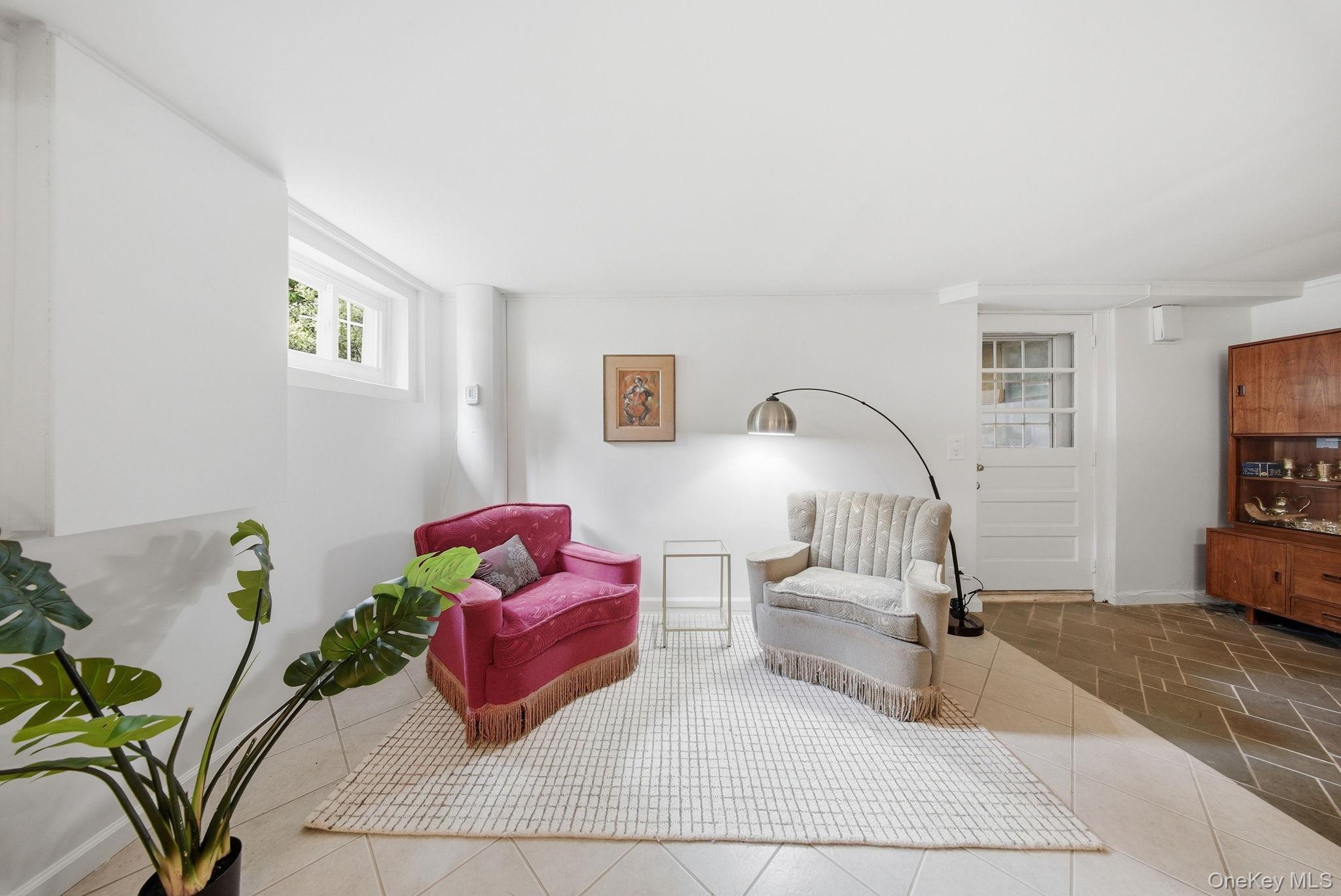 172 Wards Road Livingston Manor, NY 12758 - Photo 25 of 47 Bright living area featuring a white window, light-colored square tile flooring, and a paneled door with glass inserts