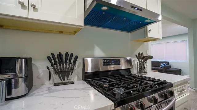 a kitchen with a stove and a refrigerator