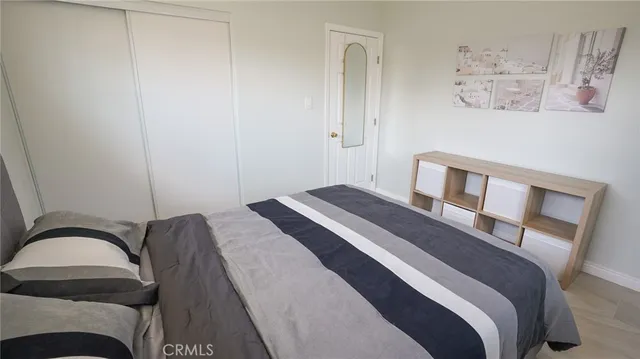 a bedroom with a bed and a mirror