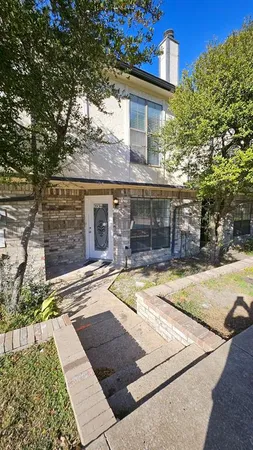 a view of a room with wooden floor and a ceiling fan