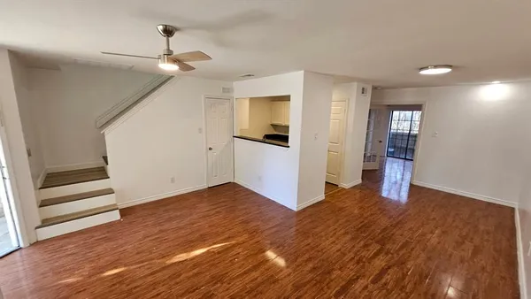 a kitchen with granite countertop white cabinets and black appliances