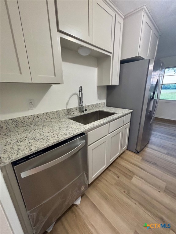 9681 Highway 53 Temple, TX 76501 - Photo 5 of 20 a kitchen with stainless steel appliances granite countertop a sink stove and cabinets