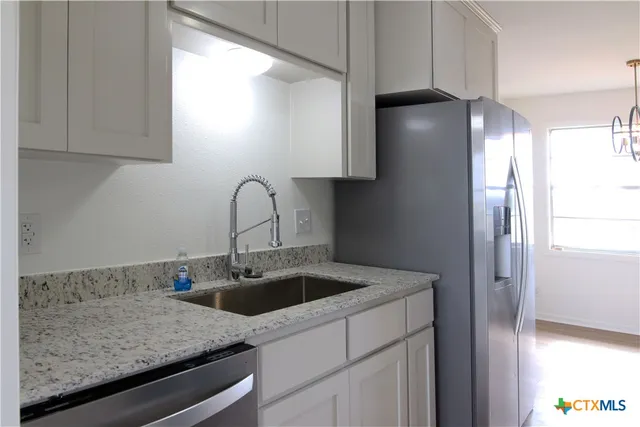 a kitchen with a sink and cabinets