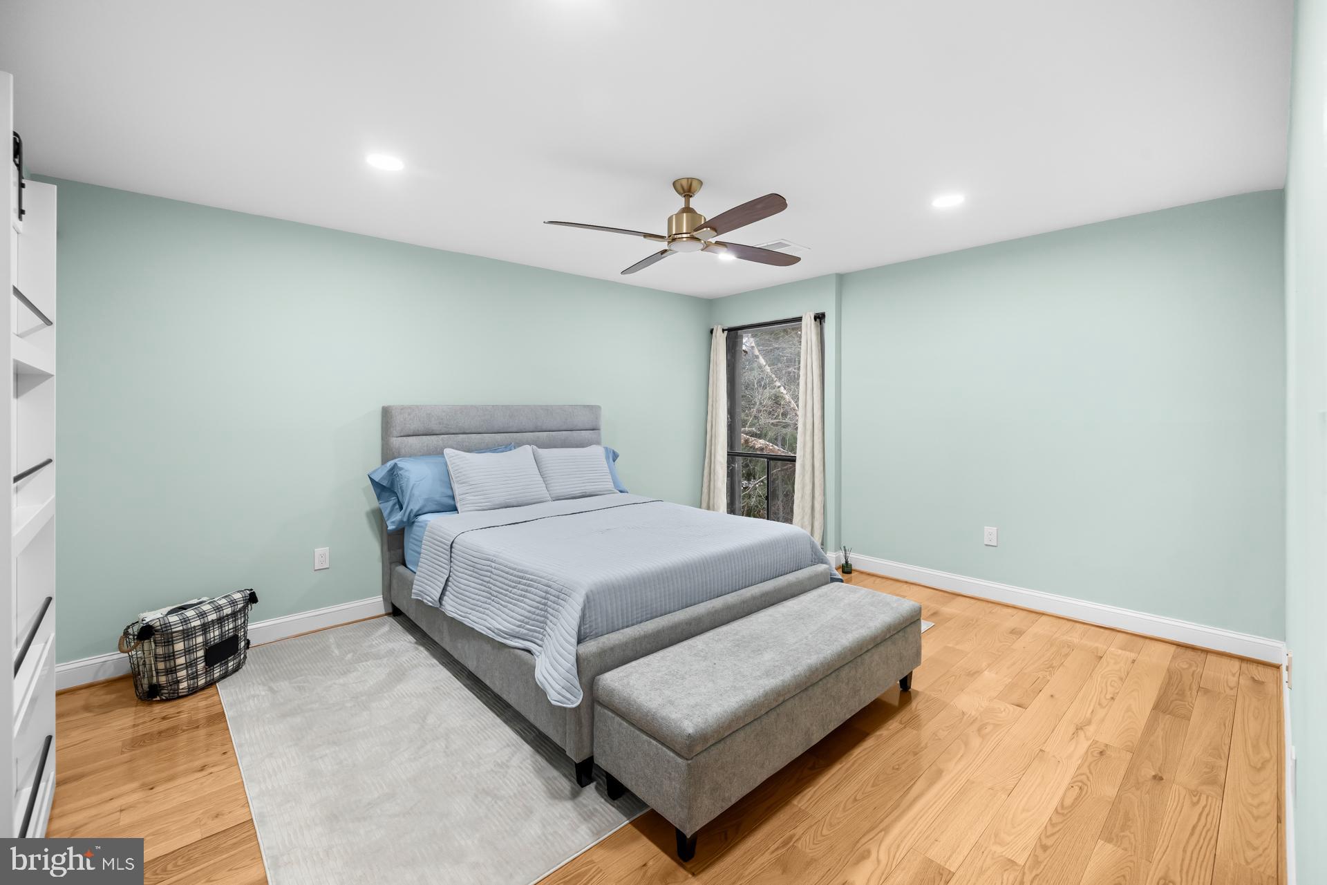 9820 Georgia Avenue, Unit 21302 Silver Spring, MD 20902 - Photo 16 of 24 Serene bedroom with soft blue accents.