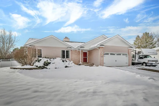 a view of a house with a yard and garage