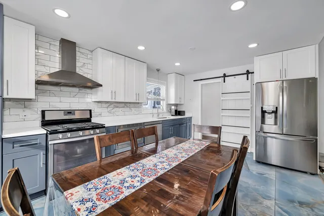 a view of a dining room with furniture and a window