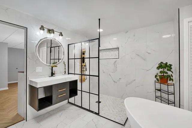 a bedroom with a bed and a wooden floor