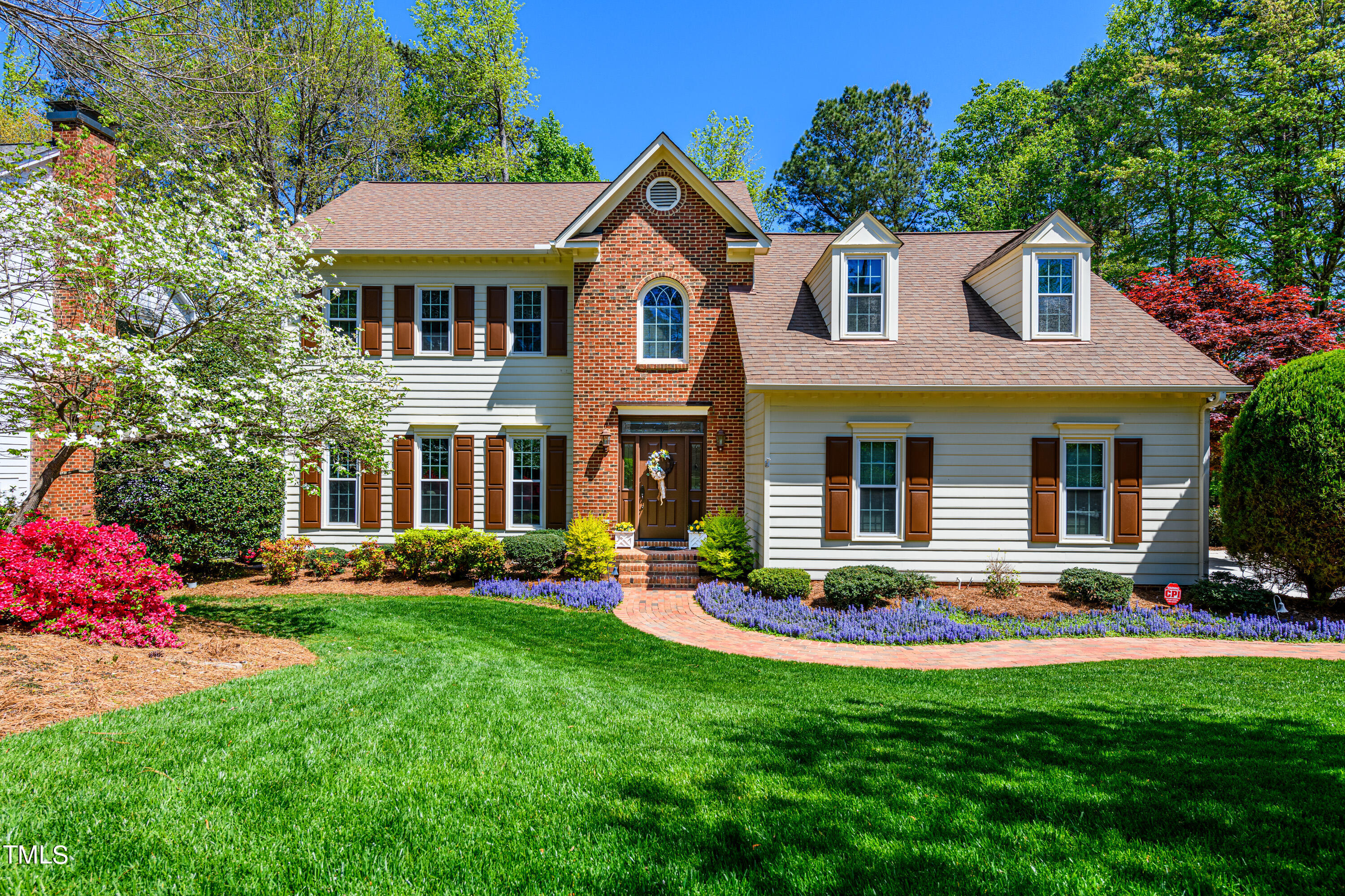 104 Kettlebridge Drive Cary, NC 27511 - Photo 1 of 48 a front view of a house with a yard table and chairs