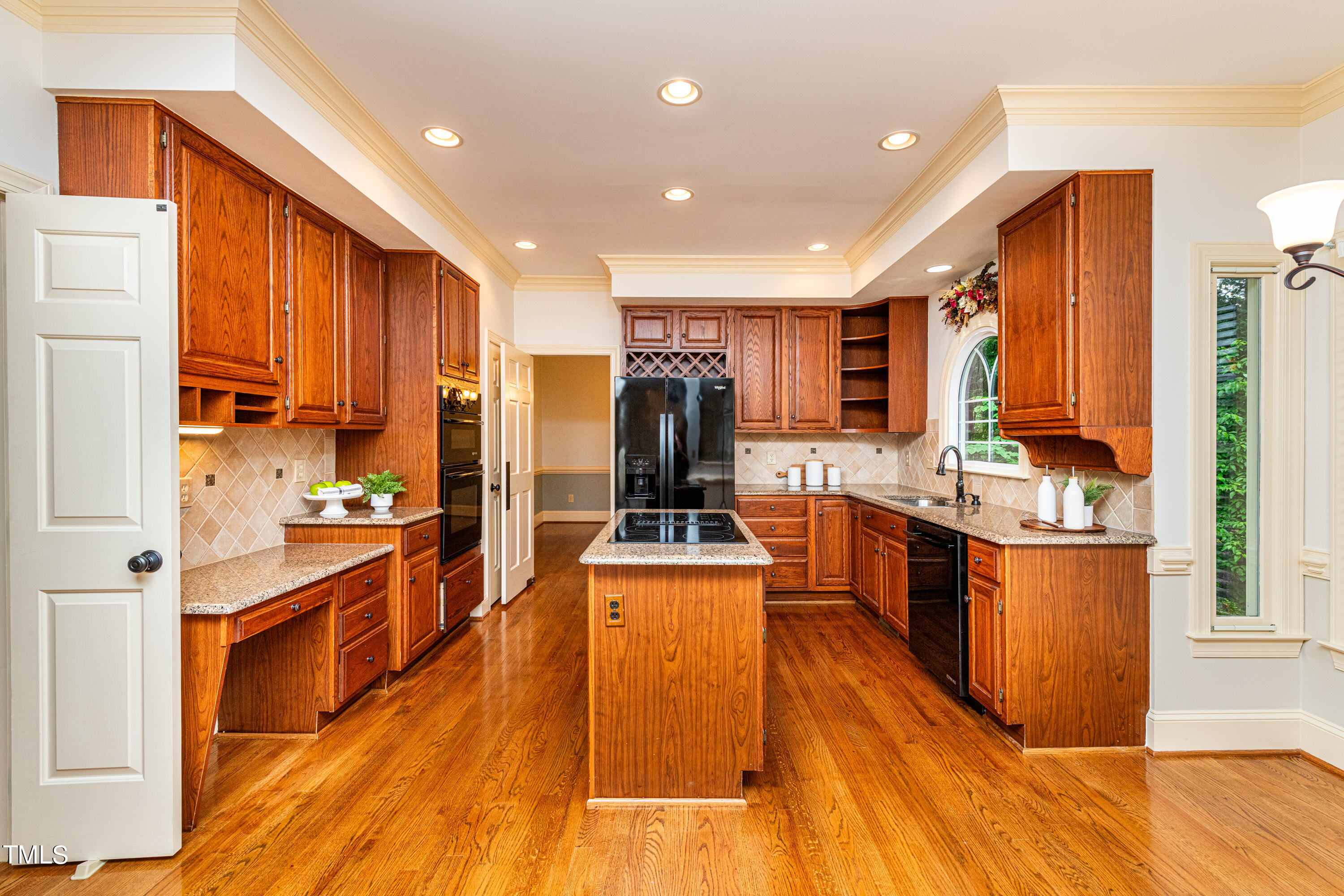 104 Kettlebridge Drive Cary, NC 27511 - Photo 16 of 48 a kitchen with stainless steel appliances granite countertop a stove top oven a sink dishwasher a refrigerator and cabinets with wooden floor