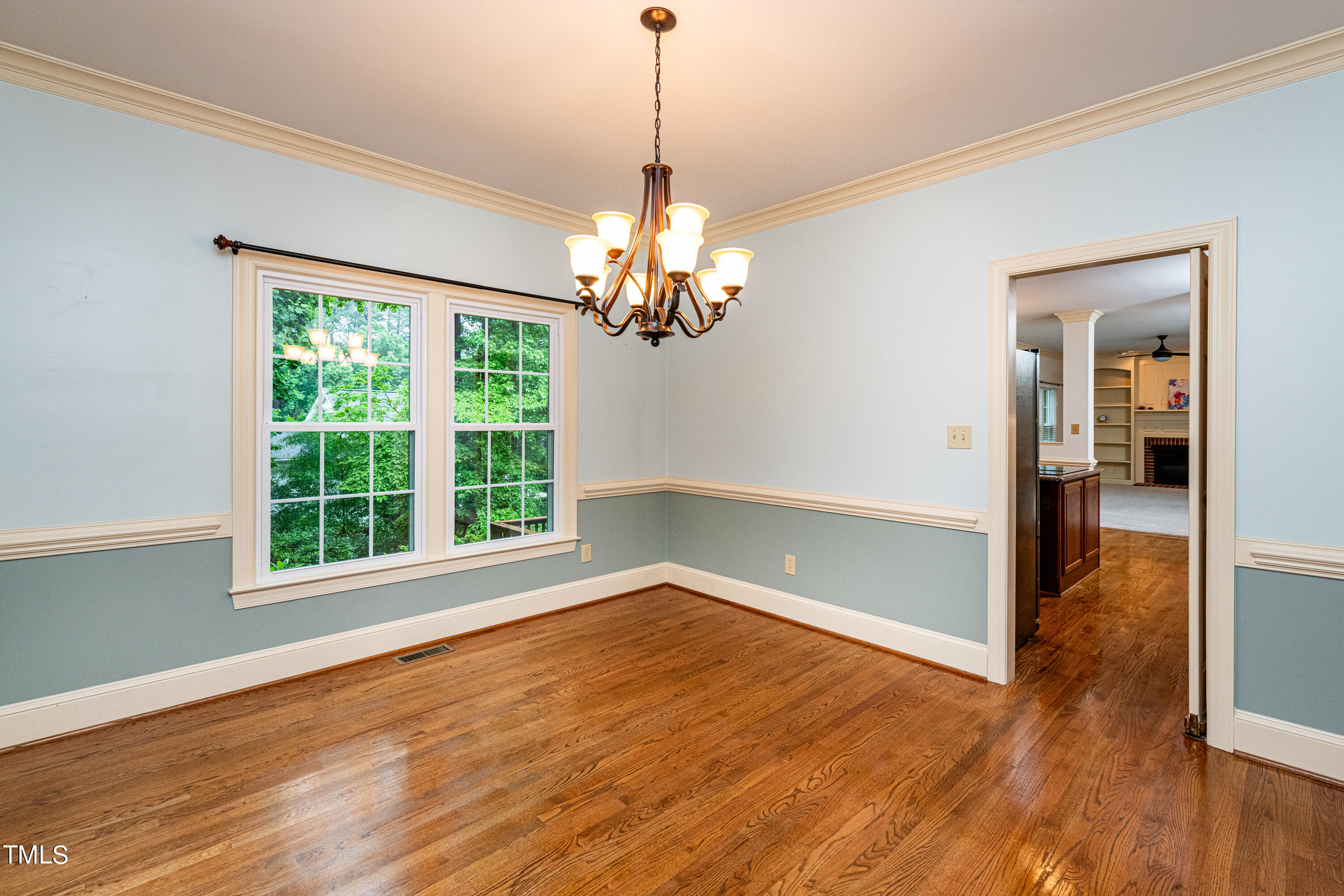 104 Kettlebridge Drive Cary, NC 27511 - Photo 21 of 48 a view of an empty room with wooden floor and a window