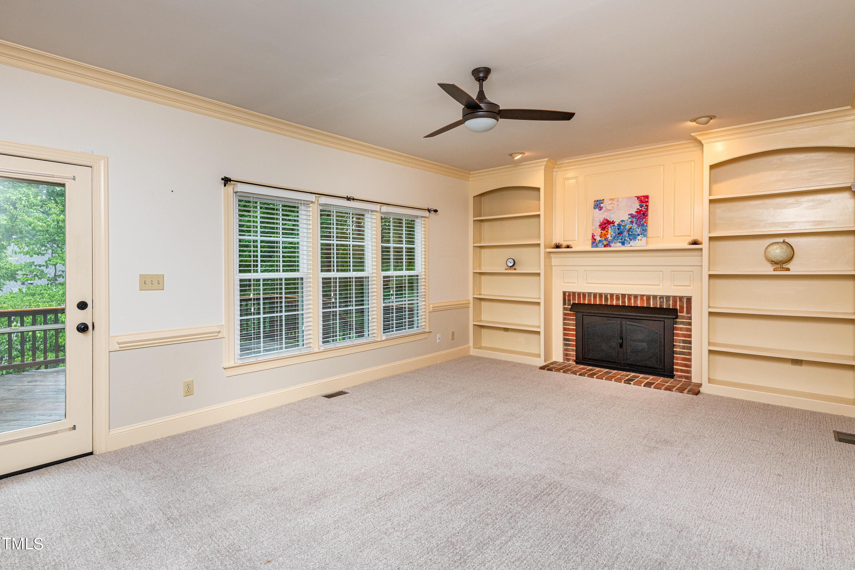 104 Kettlebridge Drive Cary, NC 27511 - Photo 22 of 48 a view of an empty room with a fireplace and a window