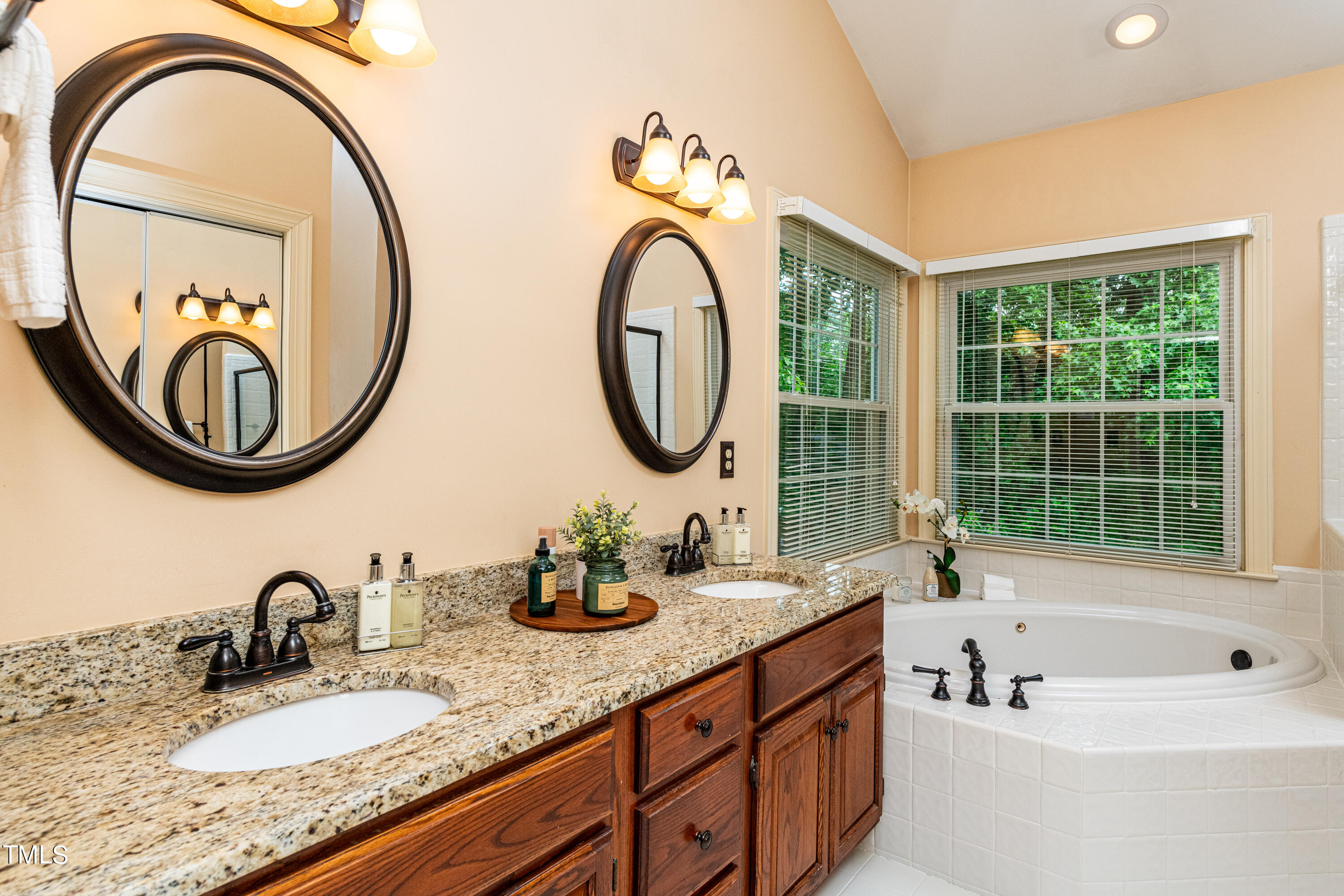 104 Kettlebridge Drive Cary, NC 27511 - Photo 29 of 48 a bathroom with a granite countertop double vanity and a large mirror