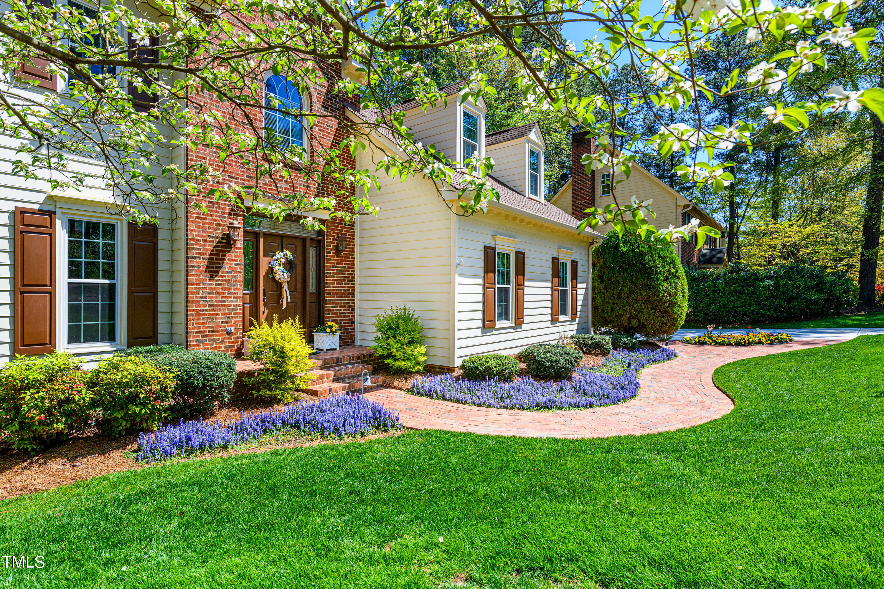 104 Kettlebridge Drive Cary, NC 27511 - Photo 3 of 48 a front view of a house with a garden and plants