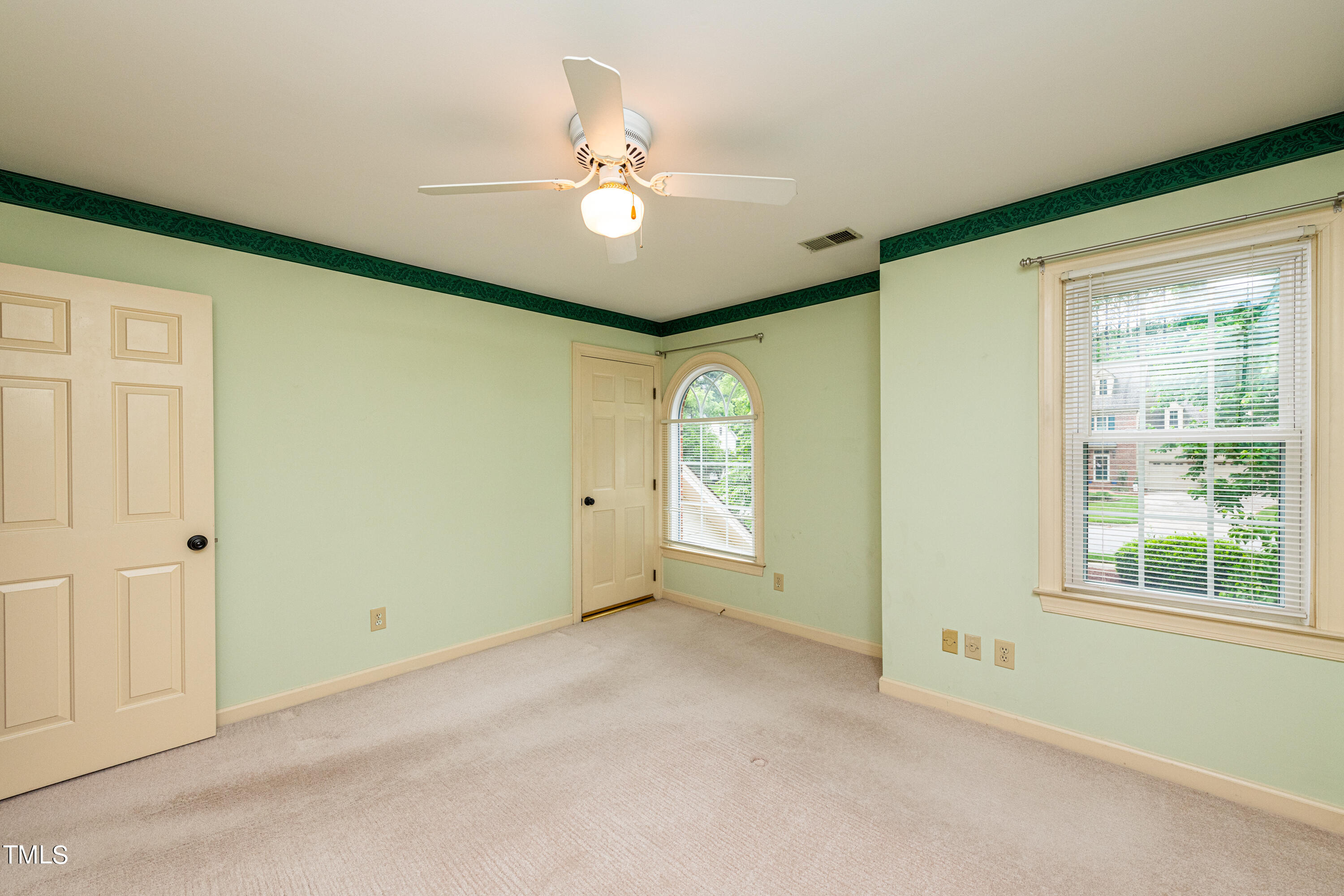 104 Kettlebridge Drive Cary, NC 27511 - Photo 33 of 48 a view of an empty room with window and chandelier fan