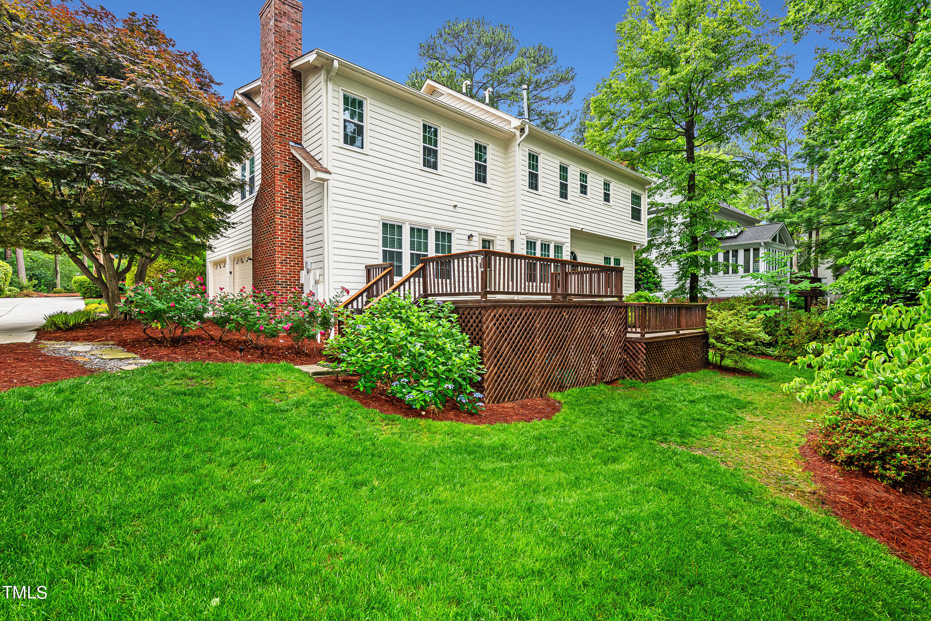 104 Kettlebridge Drive Cary, NC 27511 - Photo 40 of 48 a white house that has a small yard and a trees