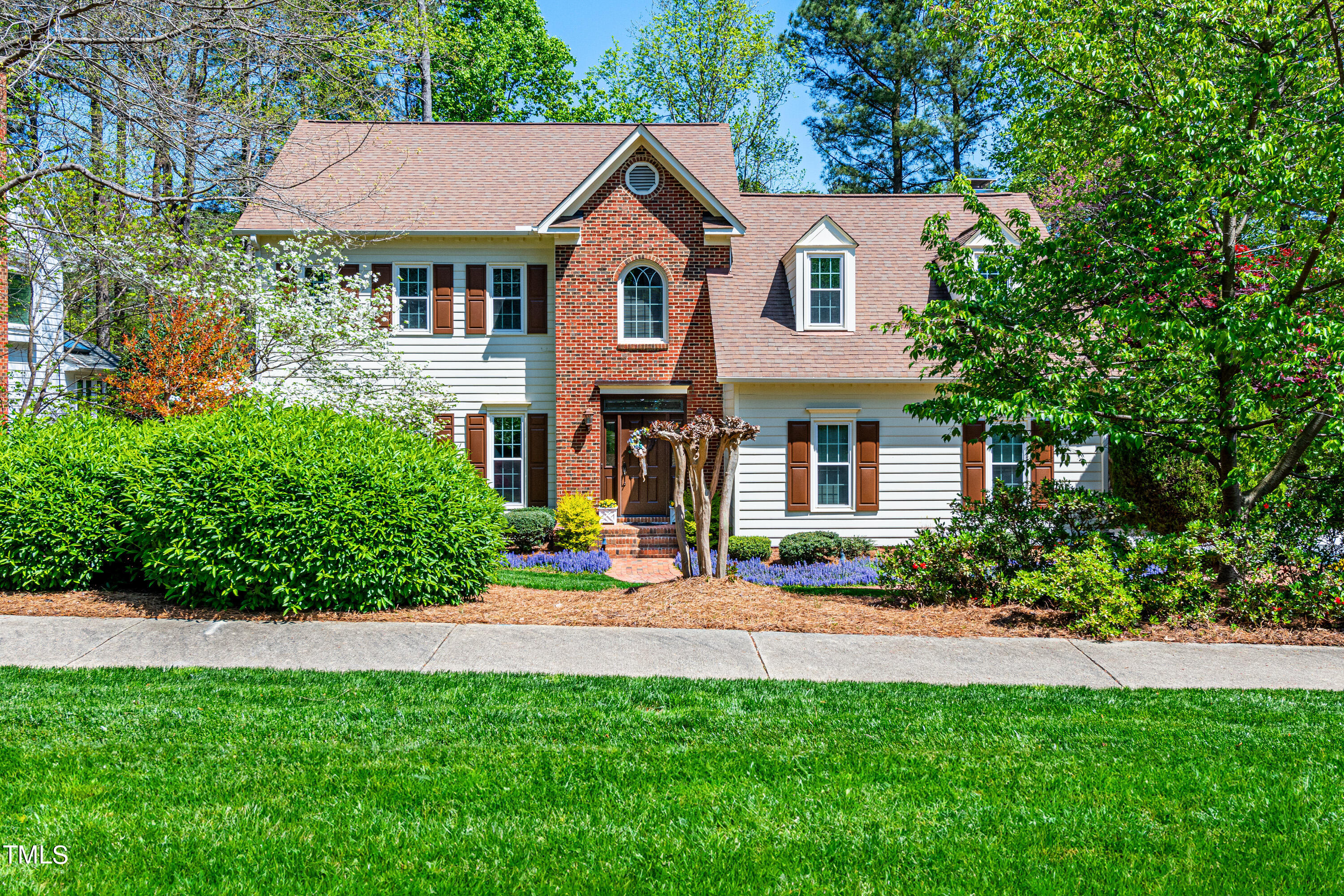 104 Kettlebridge Drive Cary, NC 27511 - Photo 48 of 48 a front view of a house with a yard and trees