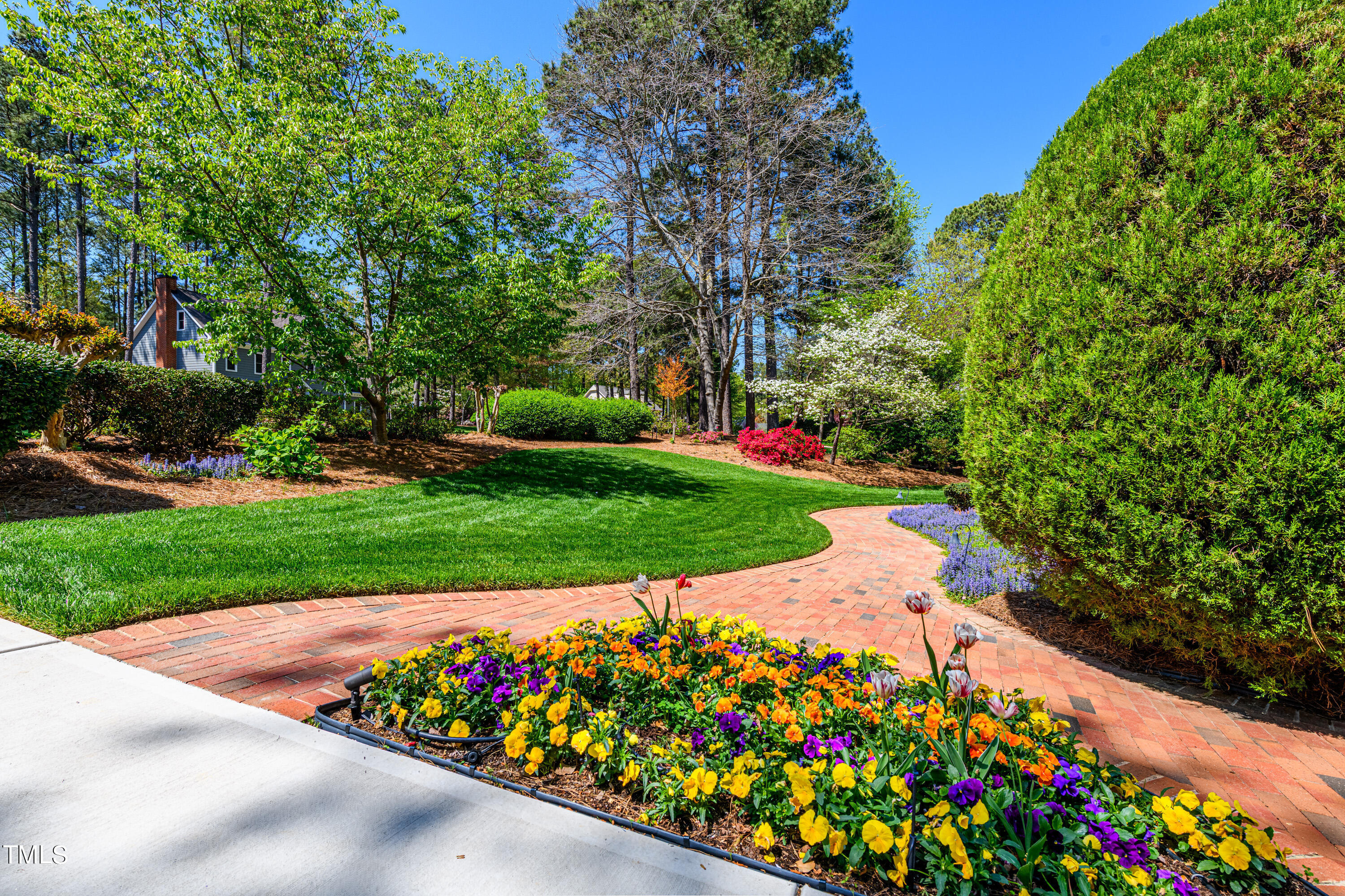 104 Kettlebridge Drive Cary, NC 27511 - Photo 5 of 48 a view of a garden with flowers