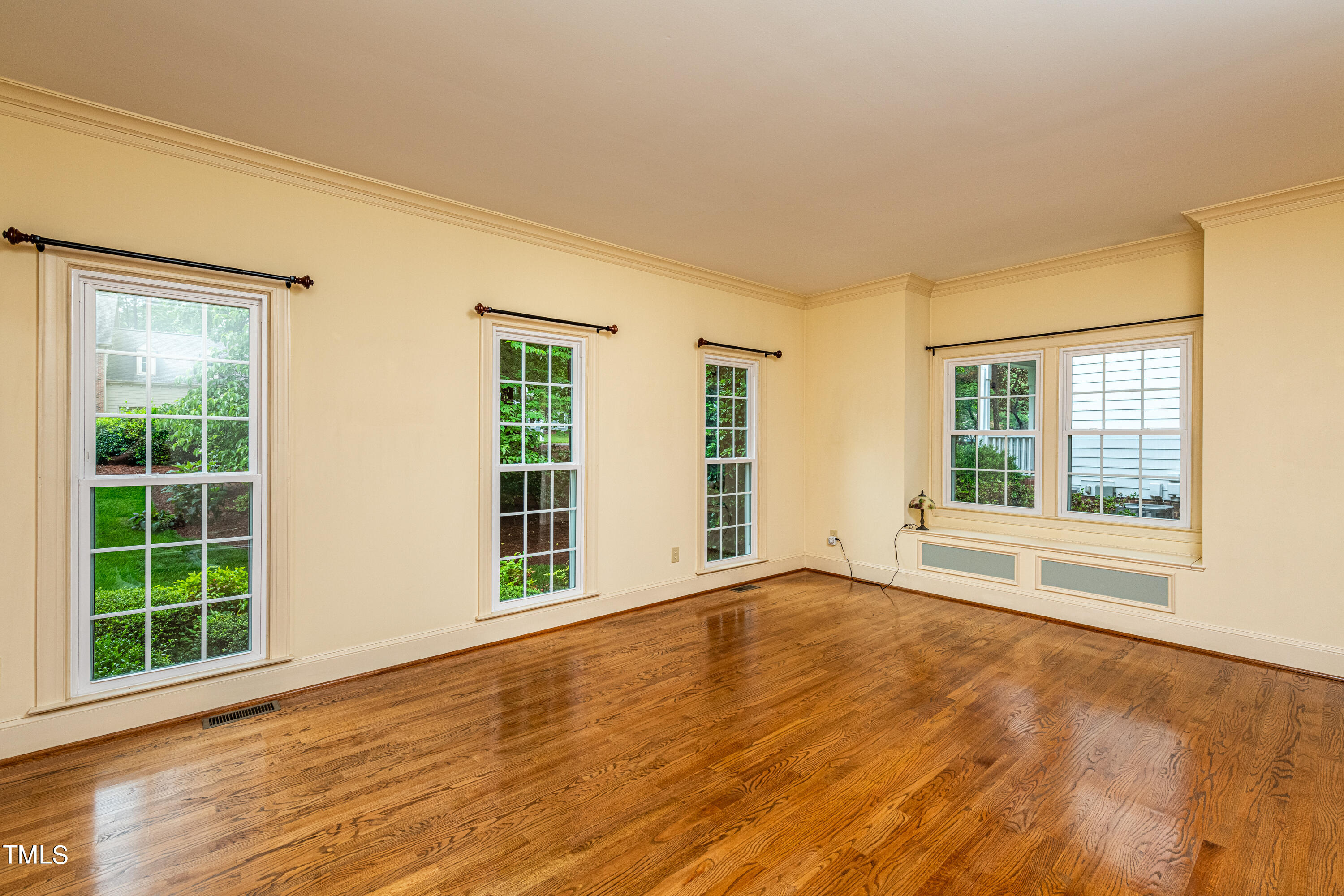 104 Kettlebridge Drive Cary, NC 27511 - Photo 8 of 48 a view of an empty room with wooden floor and a window