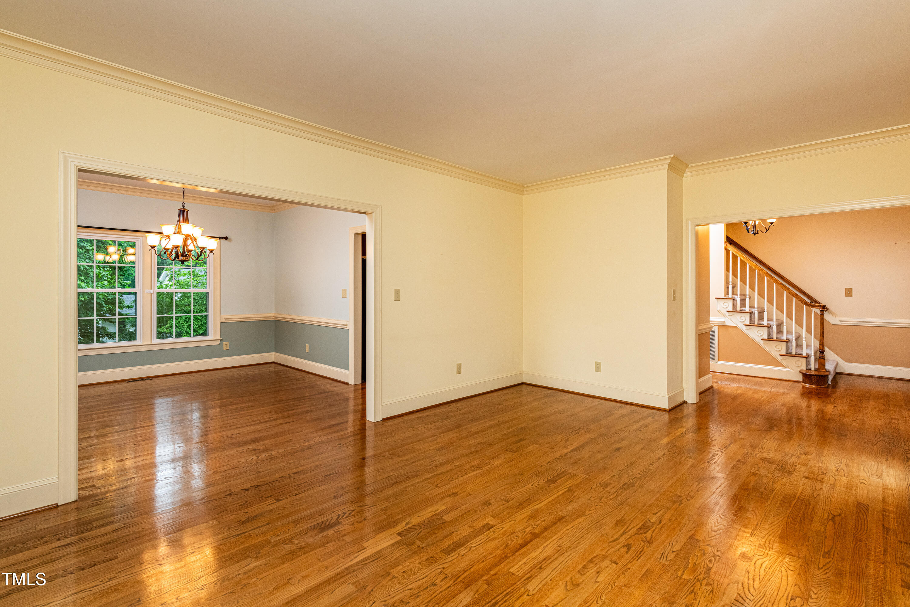 104 Kettlebridge Drive Cary, NC 27511 - Photo 9 of 48 a view of an empty room with wooden floor and a window