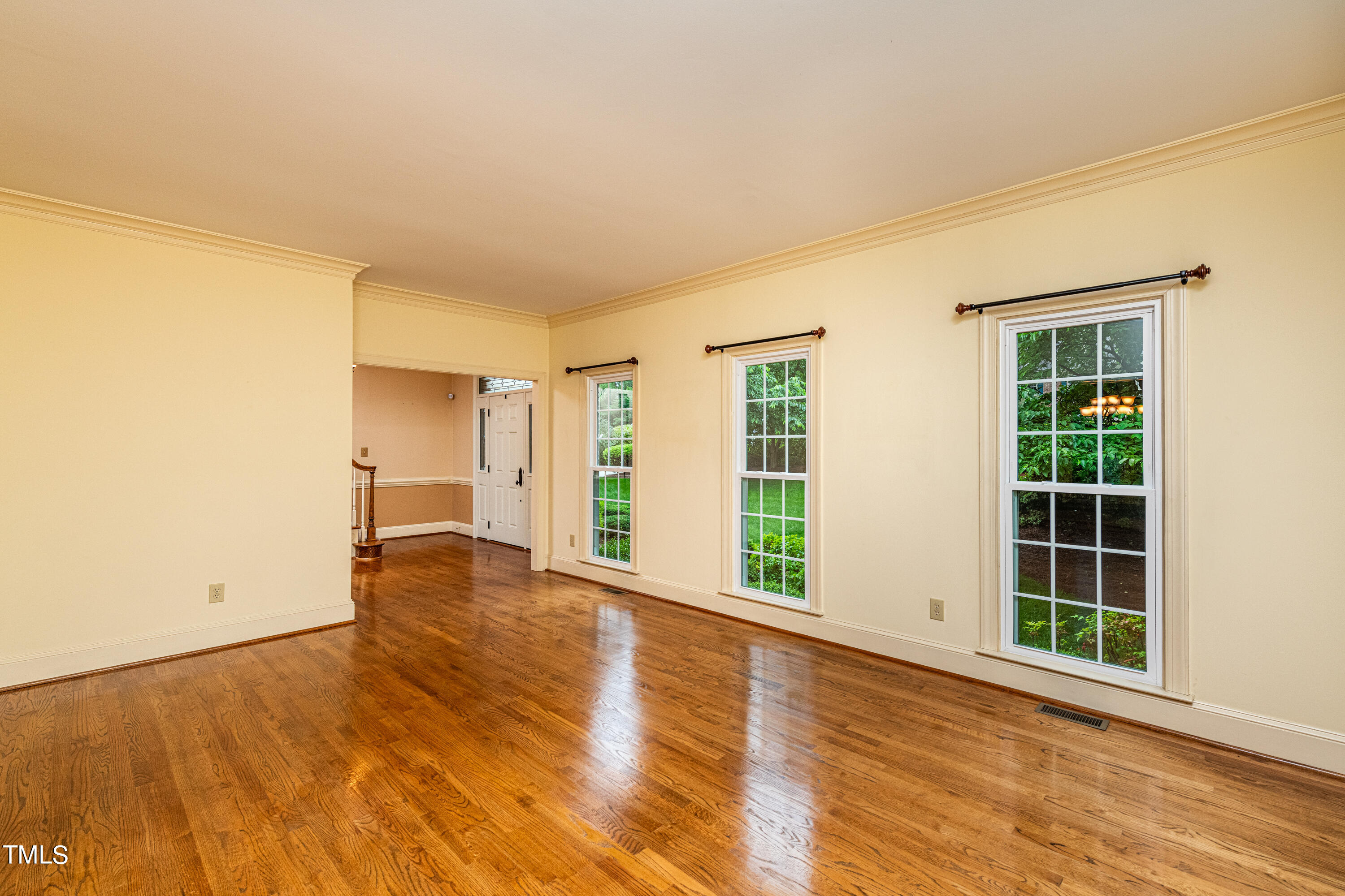 104 Kettlebridge Drive Cary, NC 27511 - Photo 10 of 48 an empty room with wooden floor and windows