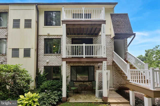 a view of front door of house with stairs