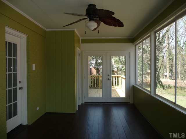 122 Lord Ashley Road Raleigh, NC 27610 - Photo 8 of 25 The Sun Porch opens to the new deck overlooking the landscaped and fenced back yard, part of the 0.72 acre, gently sloping lot.