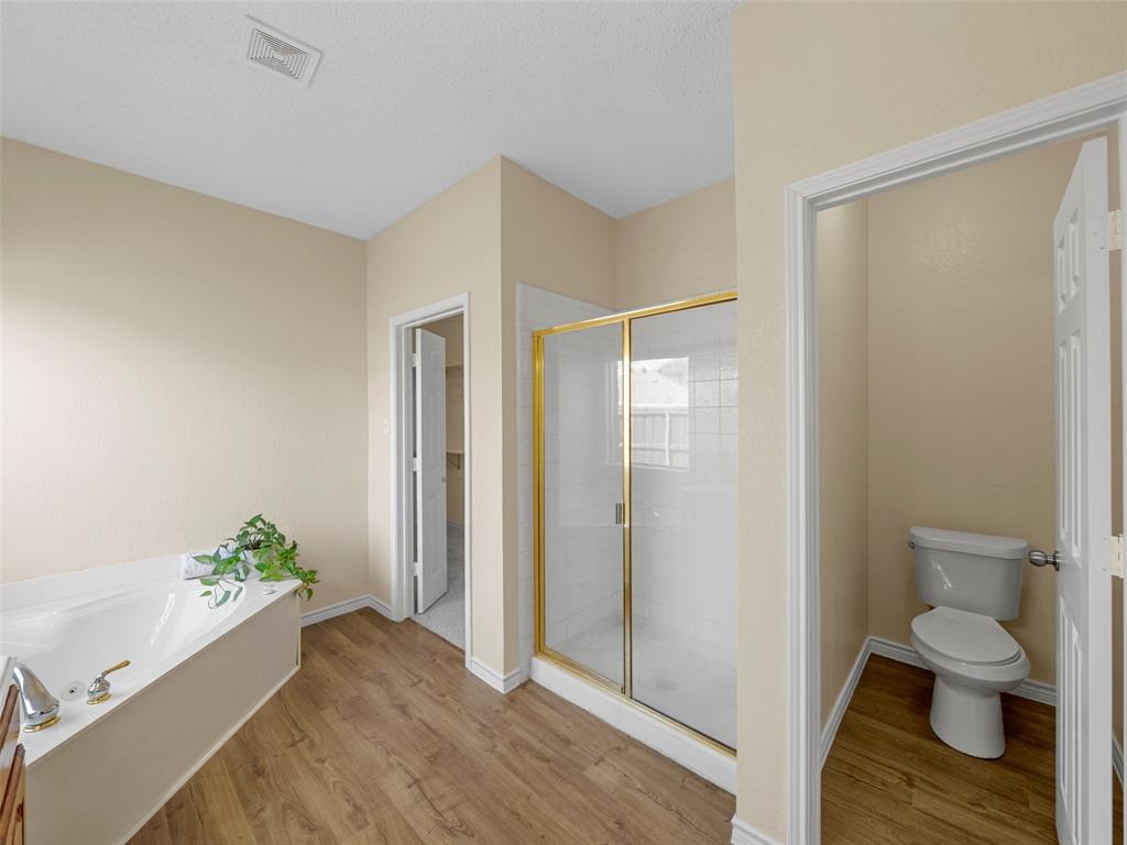 741 Aspen Court Allen, TX 75002 - Photo 25 of 40 Primary Bathroom featuring light wood-style floors, a stall shower, and a garden tub and HUGE walk in closet