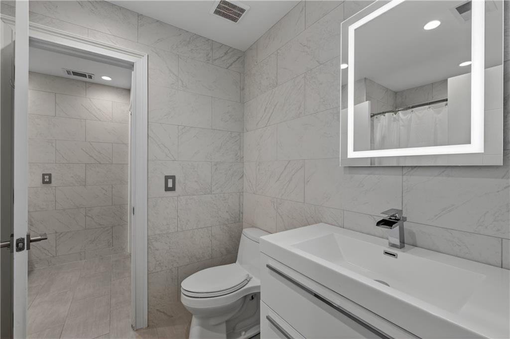 4610 West Morton Road Alpharetta, GA 30022 - Photo 23 of 53 a bathroom with a sink toilet and shower