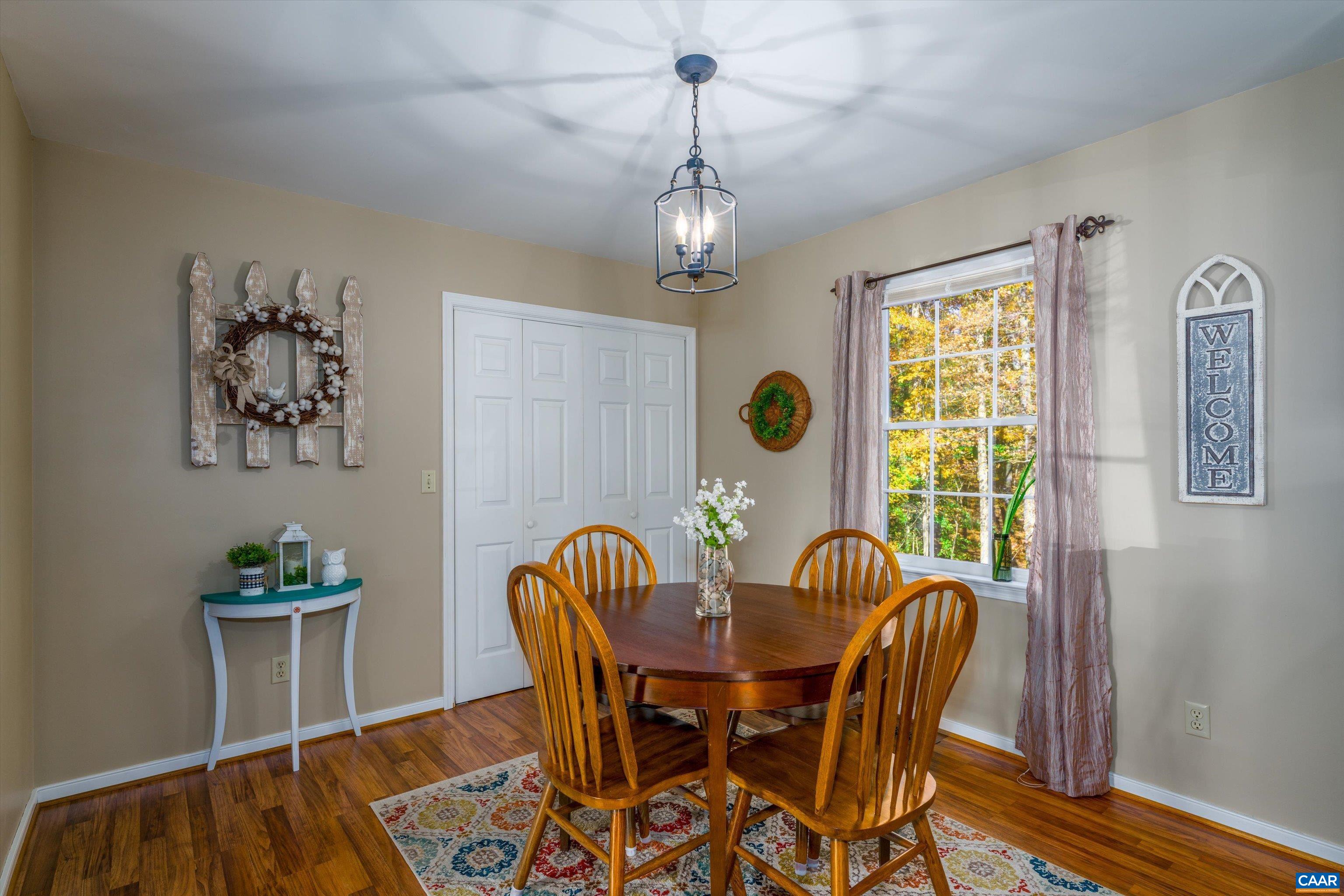 2321 Ruritan Lake Road Scottsville, VA 24590 - Photo 16 of 35 a view of a dining room with furniture window and wooden floor