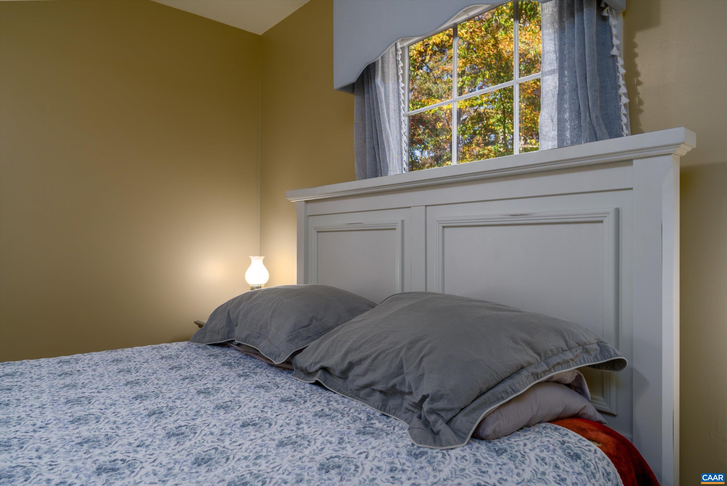 2321 Ruritan Lake Road Scottsville, VA 24590 - Photo 23 of 35 a bedroom with a bed and a window