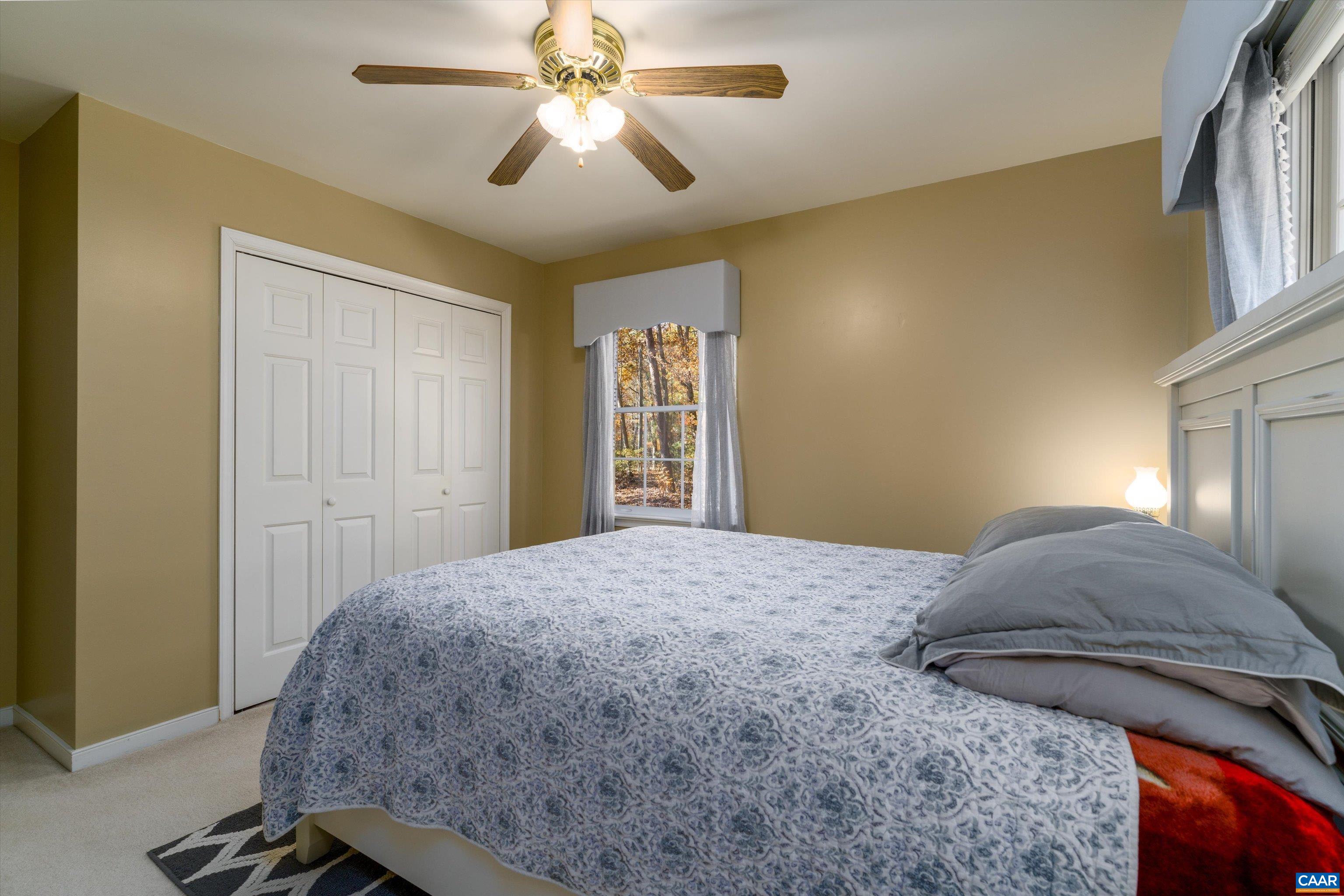 2321 Ruritan Lake Road Scottsville, VA 24590 - Photo 25 of 35 a bedroom with a bed and a chandelier