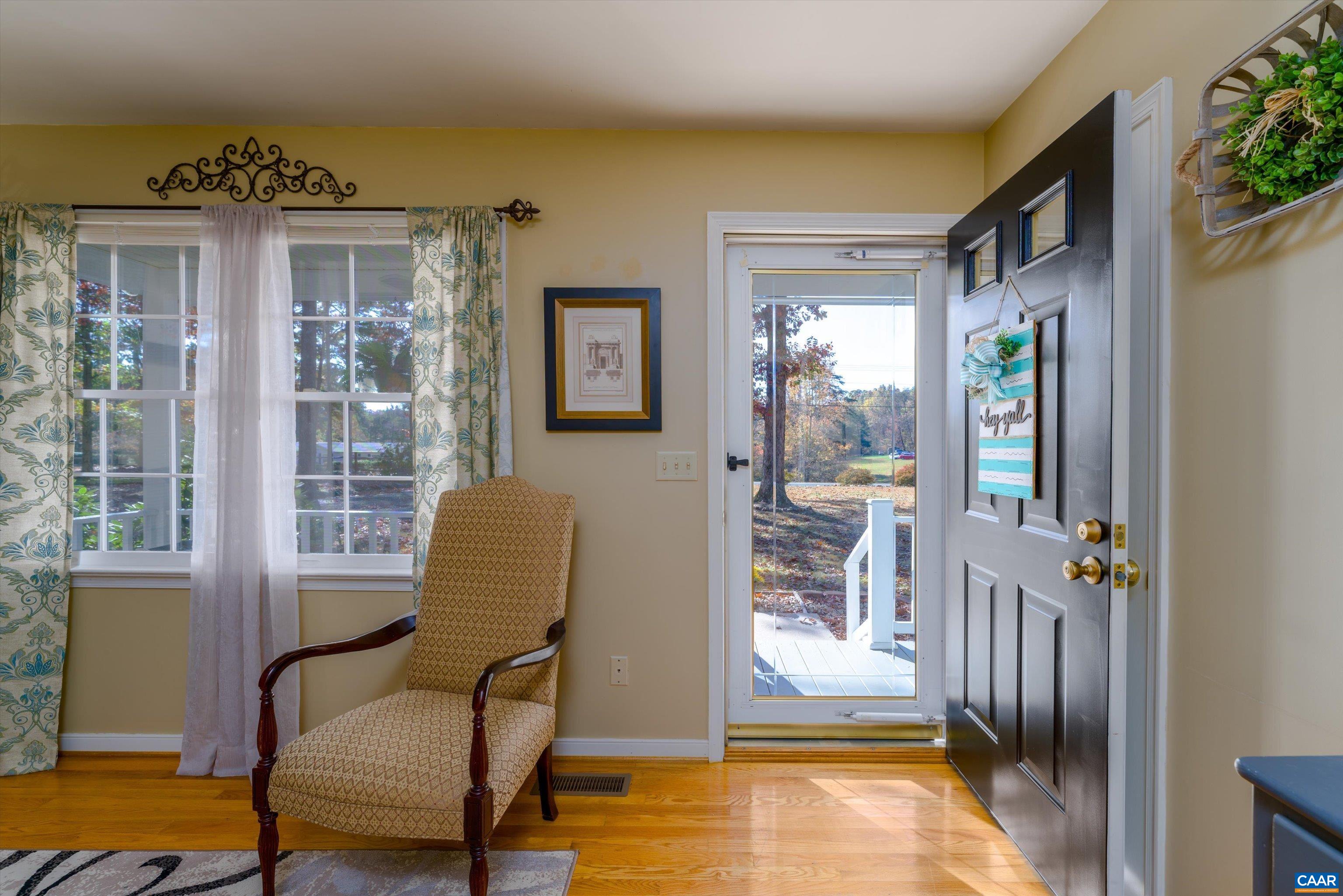 2321 Ruritan Lake Road Scottsville, VA 24590 - Photo 9 of 35 a living room with furniture and a floor to ceiling window