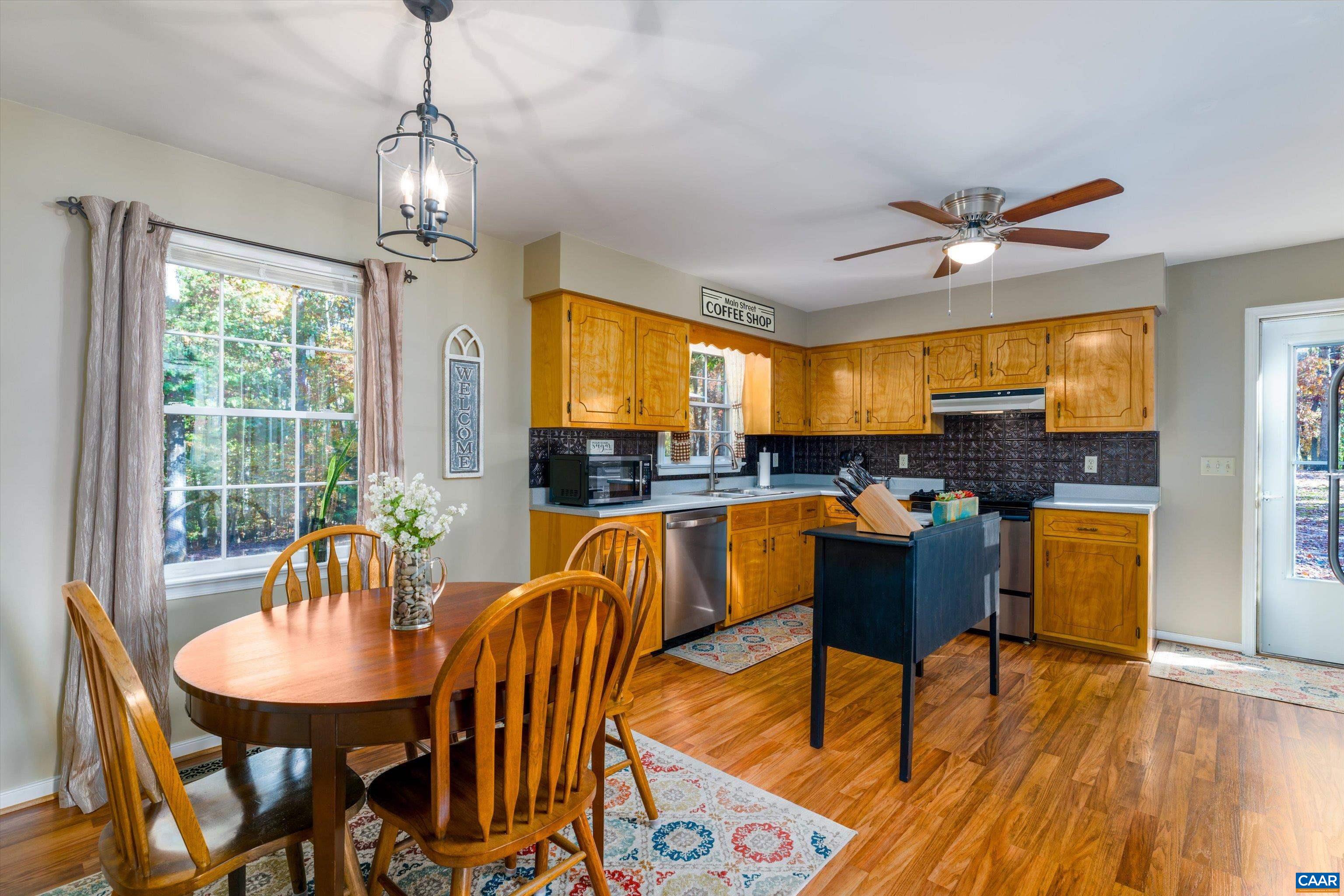 2321 Ruritan Lake Road Scottsville, VA 24590 - Photo 10 of 35 a view of a dining room with furniture window and wooden floor