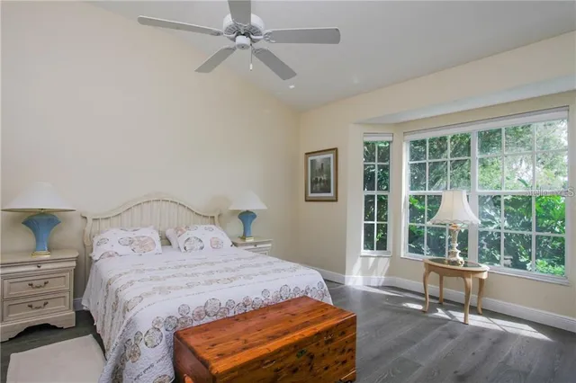 a bedroom with a bed and a large window