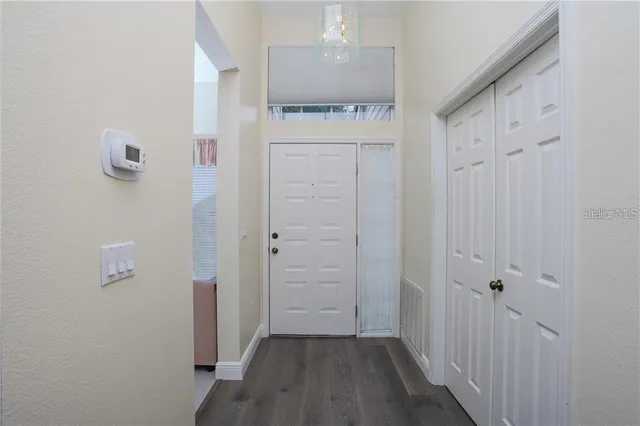 a view of a hallway with wooden floor