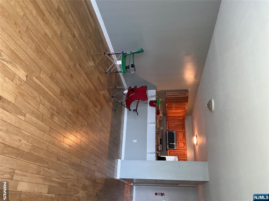 102 Berry Street, Unit 5 Hackensack, NJ 07601 - Photo 5 of 13 a room with wooden floor and furniture