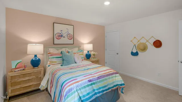 a bedroom with a bed and painting on the wall