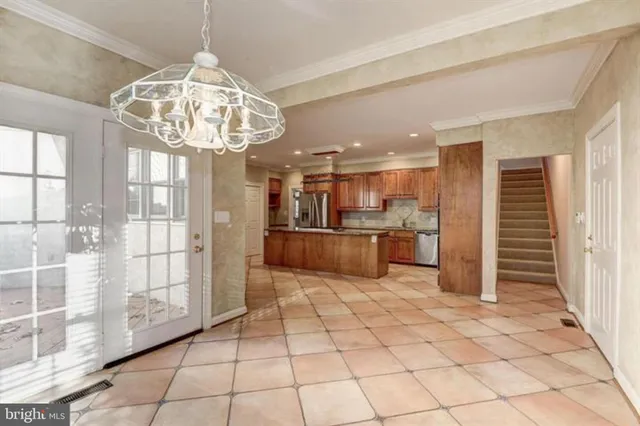 a kitchen with stainless steel appliances granite countertop a refrigerator and a sink