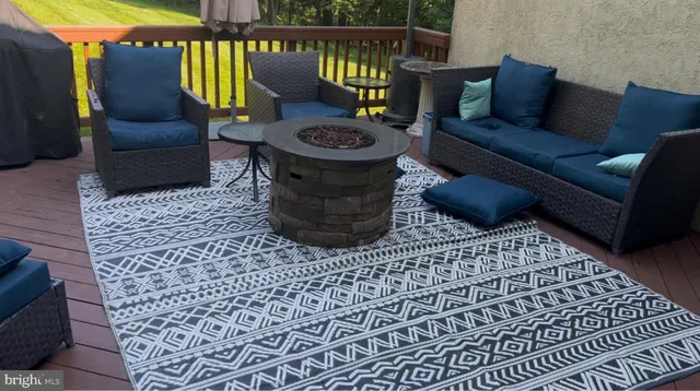 a outdoor living room with furniture and a rug